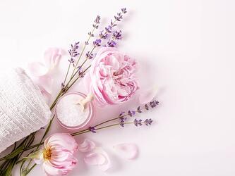 selection of flowers, bath salts and towel